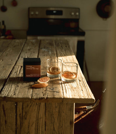 Candle box next to cocktail glass on kitchen table